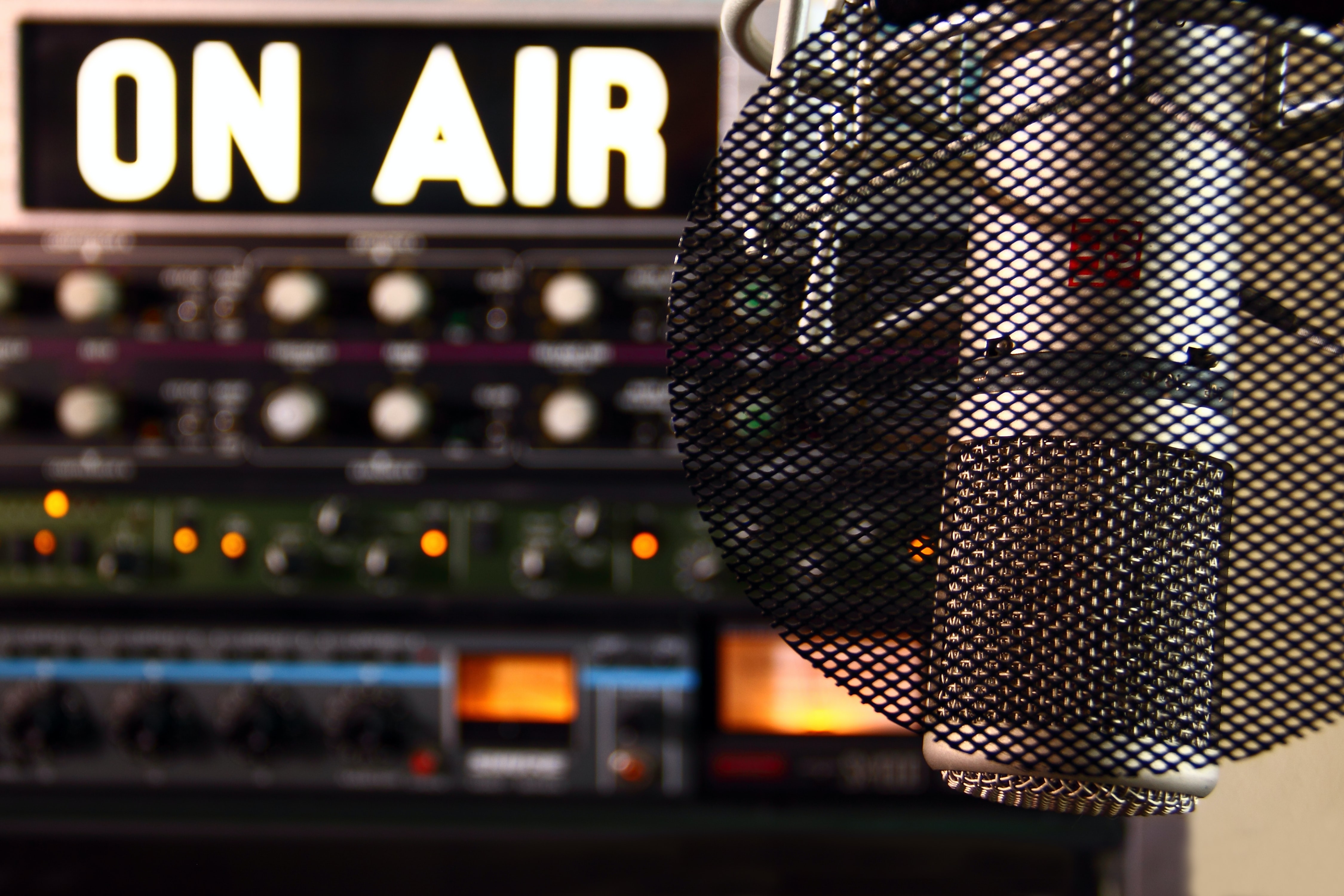 A radio show setup: On Air sign is on behind a microphone 